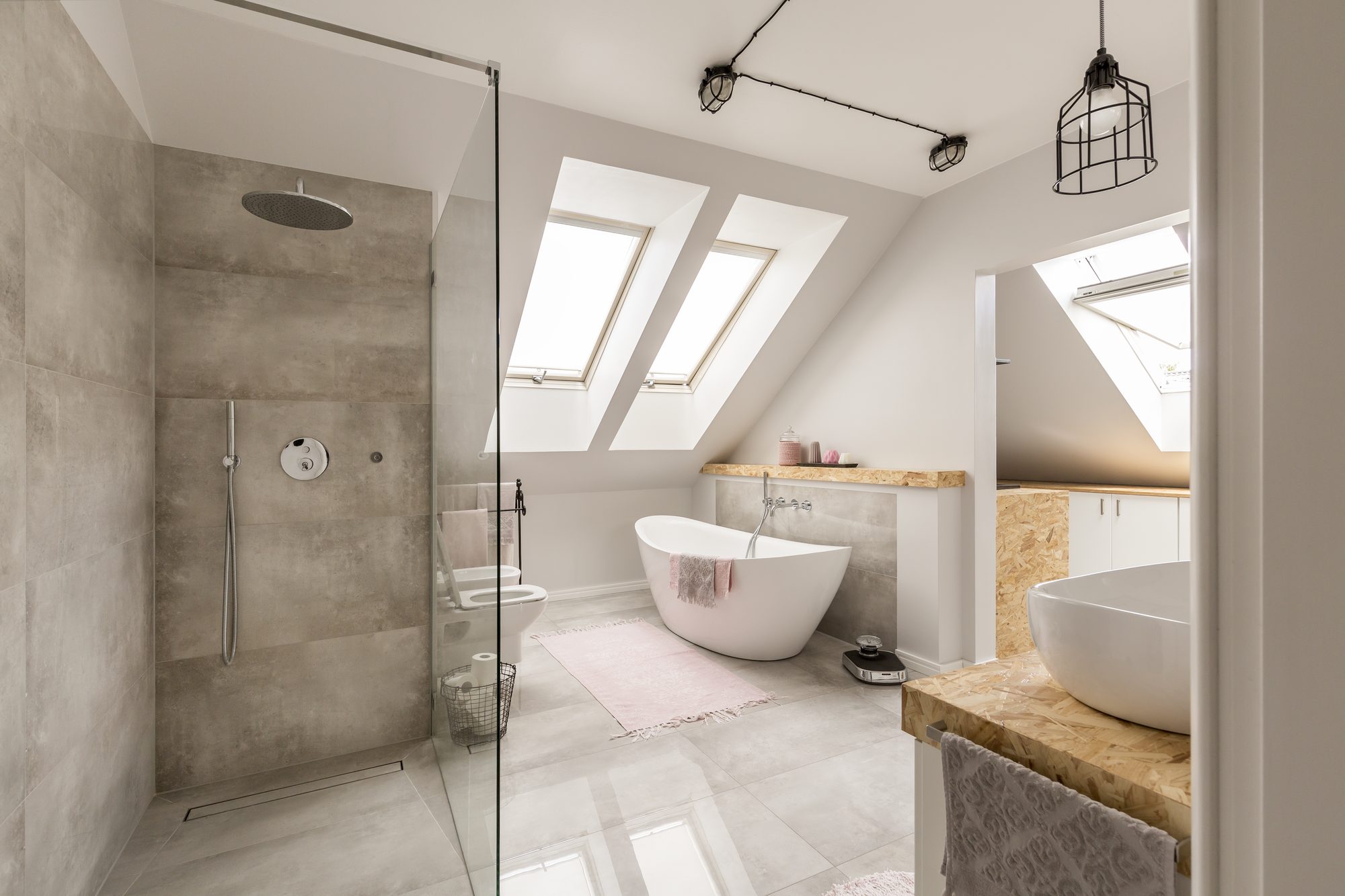 A bright bathroom with a freestanding tub and a glass walk-in shower