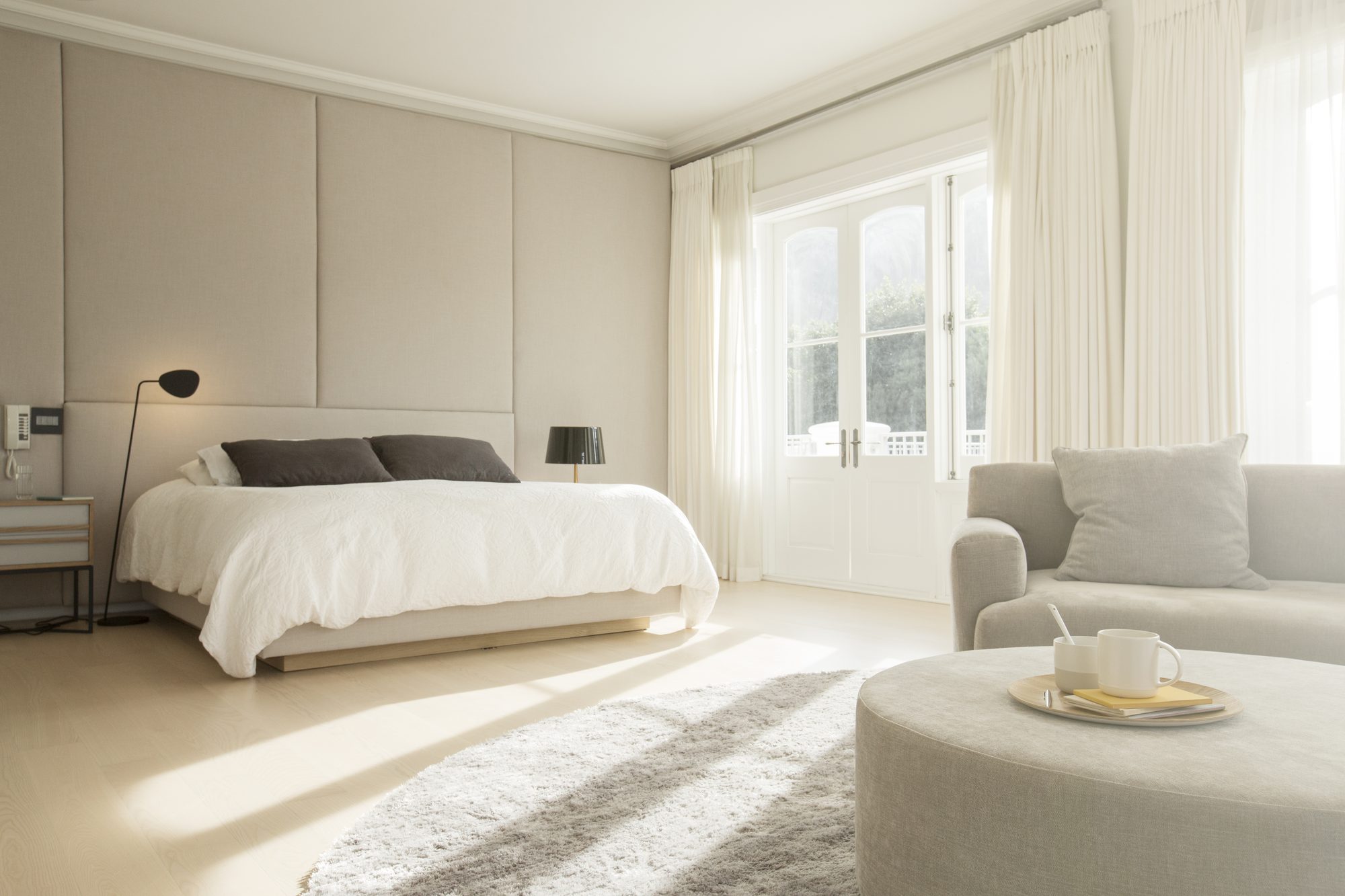 A freestanding tub set beneath a bright window