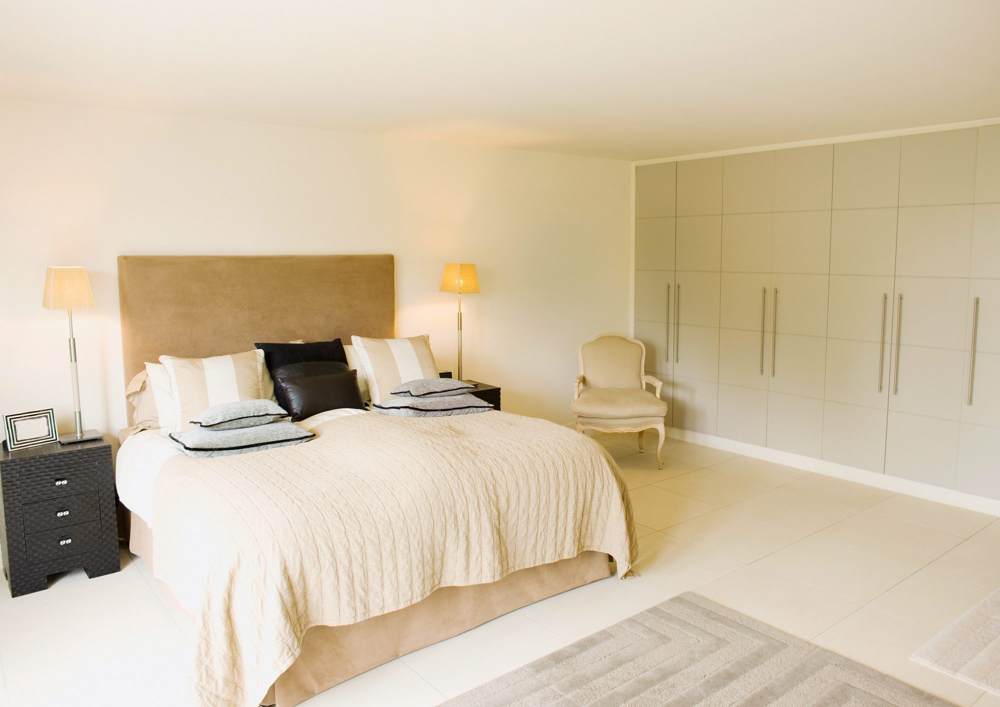 A calm remodeled bedroom in warm neutral tones